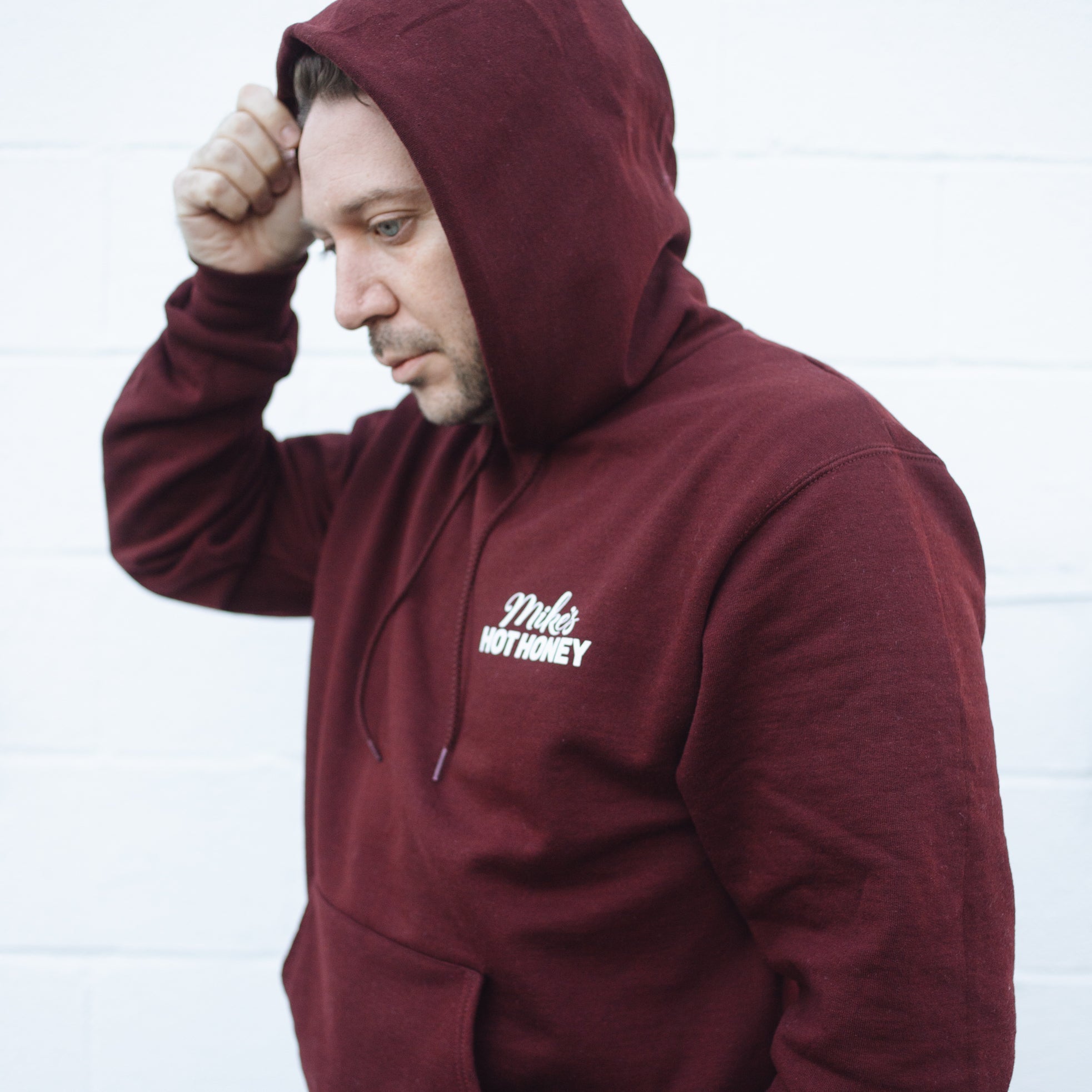 Man wearing Mike's Hot Honey pullover sweater